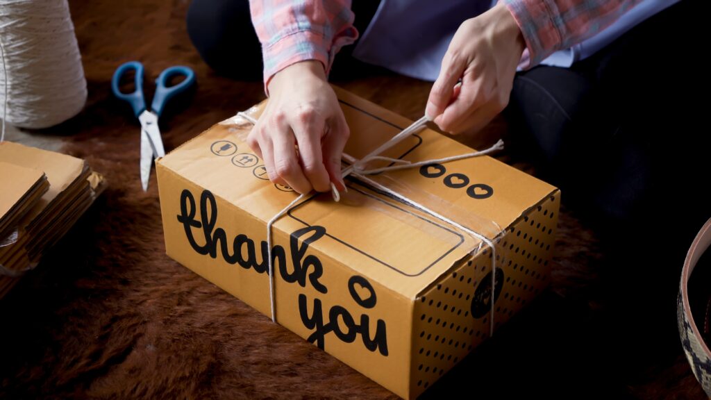 A person wrapping branded packaging